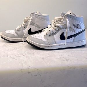 Air Jordan high tops barley worn. Grey shoe with white and black accents.
